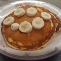 Banana Cakes · Our buttermilk pancakes cooked to perfection with banana slices inside and topped with more ...