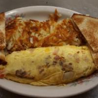 Farmer's Special Omelet · Ham, bacon, sausage, potatoes, tomatoes, onions and cheddar cheese.