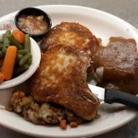 Breaded Pork Chops · Two 6 oz. bone-in-hand breaded chops served with hot apple compote.
