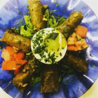 Dolmas · Grape leaves stuffed with rice, pine nuts and spices with tzatziki.