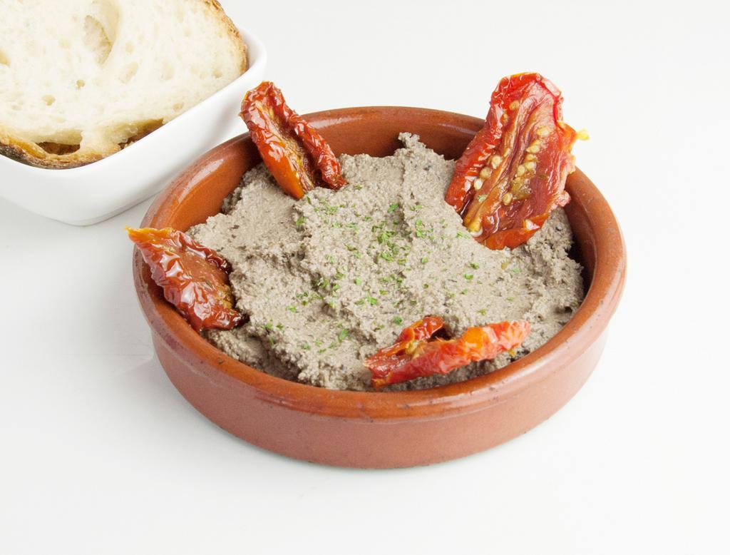 Olive Tapenade with sundried tomato · Sun-dried tomatoes and tapenade. Served with bread. 100% vegan, organic, GF and SF