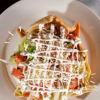 Taco Salad · Flour tortilla bowl filled with ground beef or chicken, topped with cheese, beans, lettuce, ...