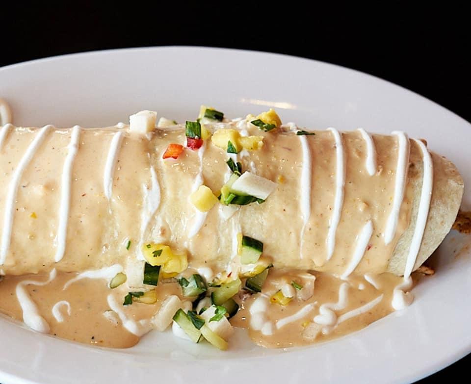 Veggie Burrito · Burrito stuffed with grilled onions, peppers, mushrooms, spinach, rice and beans topped with cheese.