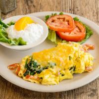 2. Spinach Scrambled Combo · 2 fresh scrambled eggs mixed with fresh spinach and diced tomatoes topped with melted chedda...