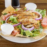 TACO SALAD · Fresh greens, sliced chicken breast, cheddar cheese and pinto beans with tortilla chips and ...