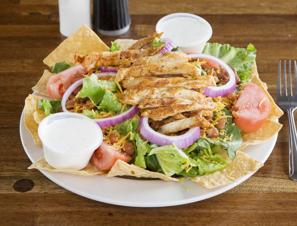 TACO SALAD · Fresh greens, sliced chicken breast, cheddar cheese and pinto beans with tortilla chips and choice of dressing.