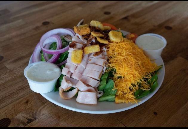 Cobb Salad · Fresh greens, turkey, bacon, cheddar cheese, mushrooms, croutons and choice of dressing.