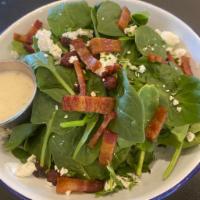 Baby Spinach Salad · Comes with crispy applewood bacon, pomegranate seeds, and goat cheese.