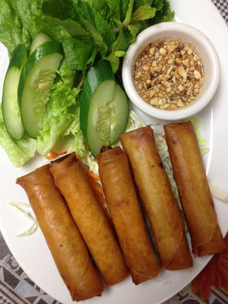 SPRING ROLLS · 5 pieces. Long rice, carrots, onions, taro, wrapped in egg paper, deep-fried golden. Served with house vinaigrette. Choice of veggie or pork.