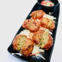 FISH PATTIES · 5 pieces. Tod mun pla. Fish patties with green beans, onions, Thai herbs and spices, deep-fr...