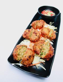 FISH PATTIES · 5 pieces. Tod mun pla. Fish patties with green beans, onions, Thai herbs and spices, deep-fried. Served with sweet chili sauce and cucumber relish