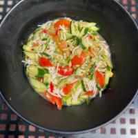 TUM MAK THAENG · Laotian Style Cucumber Salad. Shredded cucumber, tomatoes, fresh lime juice, and fish sauce.