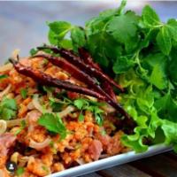NAM KHAO · Crispy Rice Salad. Deep fried rice balls, fermented pork sausage, peanuts, green onions, cil...