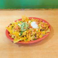 Super Nachos · Chips covered in cheese and beans topped with jalapenos, guacamole, sour cream, tomatoes and...