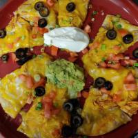Mexican Pizza · Deep-fried flour tortilla topped with beef or chicken, beans, cheese, tomatoes, green onions...