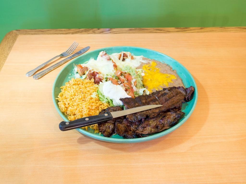 Mi Jalisco · Carne asada along with 5 bacon wrapped shrimp sauteed onions and melted cheese. Served with rice and beans, sour cream, guacamole and pico de gallo.