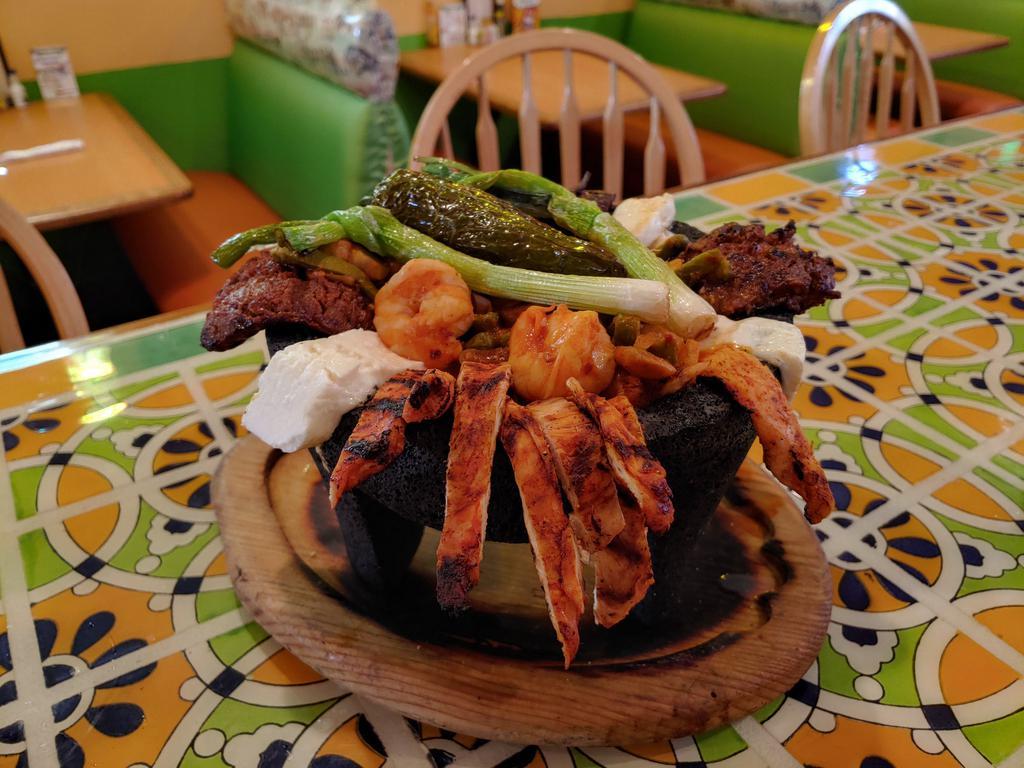 molcajete jalisco · Carne asada, Pollo asado,sauteed shirmp with onions , mushrooms, cactus, mexican cheese and  mexican sausage.