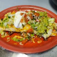 Carne Asada Burrito · Flour tortilla stuffed with char-broiled steak or grilled chicken beans, rice, covered with ...