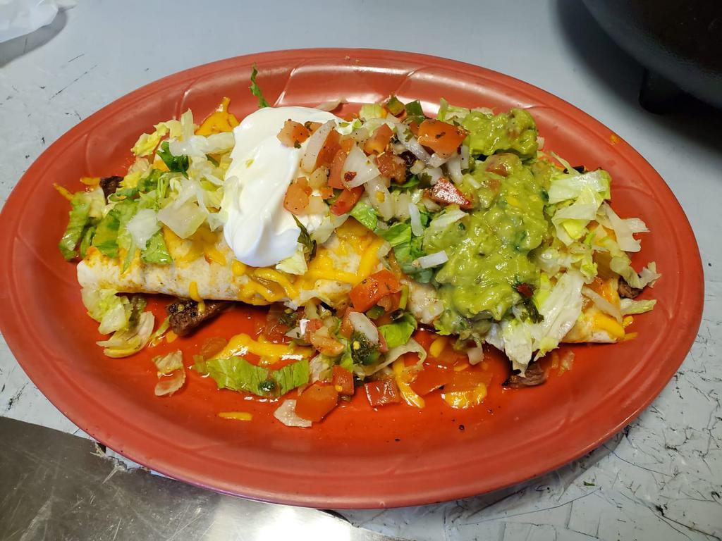 Carne Asada Burrito · Flour tortilla stuffed with char-broiled steak or grilled chicken beans, rice, covered with tomato sauce, melted cheese, fresh lettuce, pico de gallo, guacamole & sour cream.