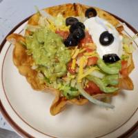 Taco Salad · A crisp deep dish flour tortilla with beans, choice of meat, lettuce, tomatoes, black olives...