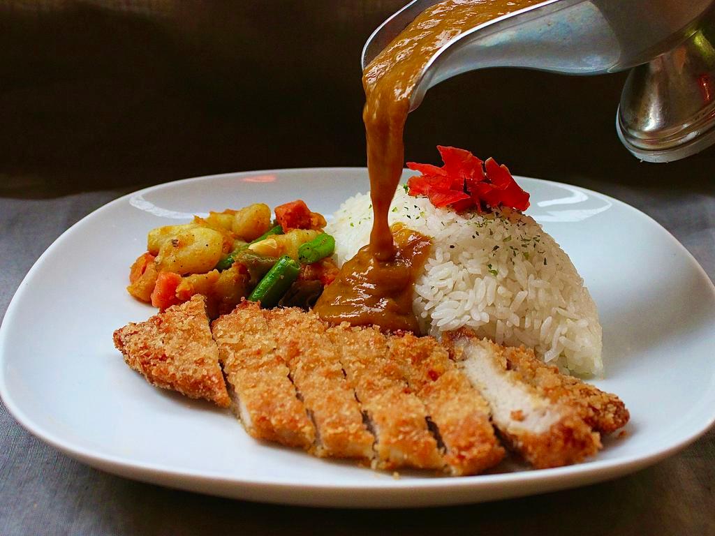 Berkshire Pork Katsu Curry · Deep-fried pork cutlet, tender inside and crispy outside served w/ curry, rice, and assorted vegetables.

