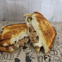 The Cuban Grilled Cheese Sandwich · Mojo marinated pulled pork, ham, Swiss, and dill pickles.