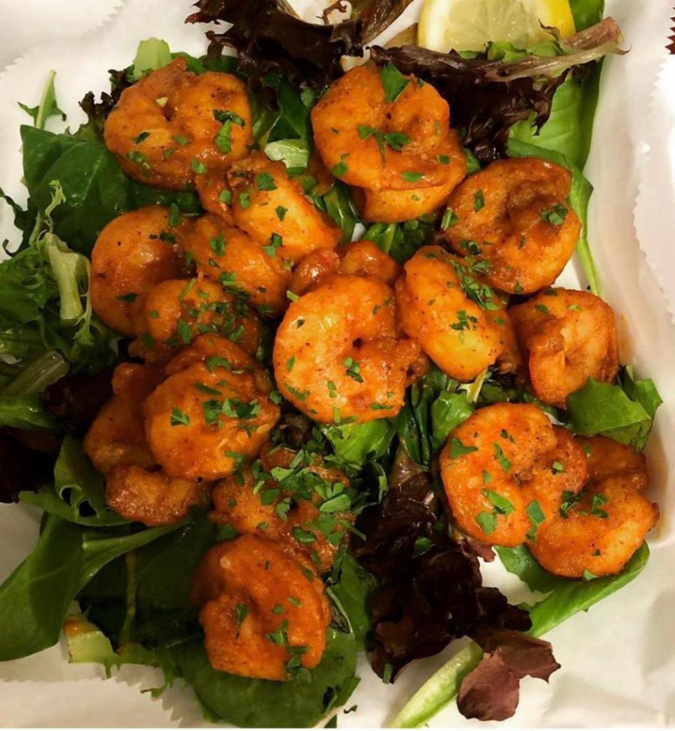 Gang Bang Skrimpz · 10 jumbo fried shrimp tossed in our signature TRAP sauce served on a bed of mixed greens.