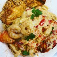 BossMane Pasta · Lobster and crawfish fettuccine Alfredo pasta topped with a salmon filet, a lobster tail and...