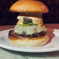 Prime Beef Burger  · Prime beef burger, housemade American cheese, smoked red onion, and heirloom tomato aioli.
