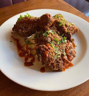 Buttermilk Fried Chicken  · Drizzled with honey and hot sauce with housemade slaw.
