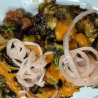 Crispy Brussels Sprouts  · Finished with romesco sauce, bacon, and maple vinaigrette.
