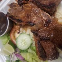 Costilla de Res Asada · Grill beef ribs. served with rice, black beans, green salad ond grill onions.