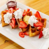 Waffles (gluten free) · Waffles made from house made batter served with honey butter and syrup on the side.