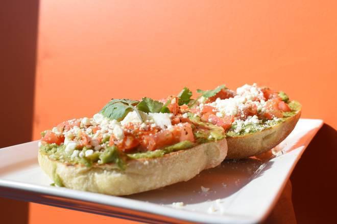 Bravocado · Ciabatta toast topped with avocado, roma tomatoes, feta cheese, and cilantro