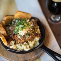 BBQ Pork Mac and Cheese · Beer-braised BBQ pulled pork, 3 cheese blend, bacon bits and garlic Parmesan crostini.