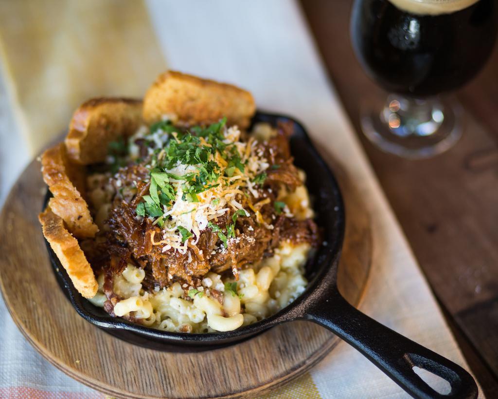 BBQ Pork Mac and Cheese · Beer-braised BBQ pulled pork, 3 cheese blend, bacon bits and garlic Parmesan crostini.