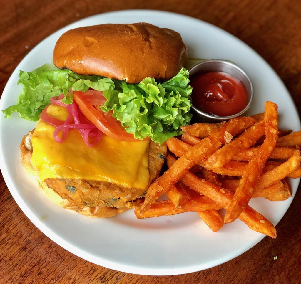 Black Bean Veggie Burger (vegetarian) · House-made veggie burger of black beans, sweet potato, & smoked farro  topped with cheddar, lettuce, tomato, pickled red onion, and chipotle-lime aioli on a brioche roll.  Served with Sweet Potato Fries.
