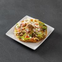 Tostada · Toasted corn tortilla, choice of 1 filling, refried beans, pico, lettuce, queso fresco, crem...