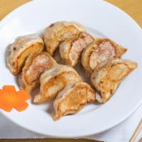 10 Pan-Fried Pork Dumplings · With scallions.