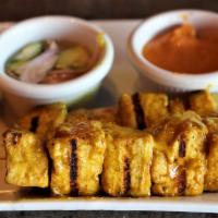 A6. Satay · 3 pieces. Marinated in a turmeric sauce. Served with cucumber sauce and peanut sauce.