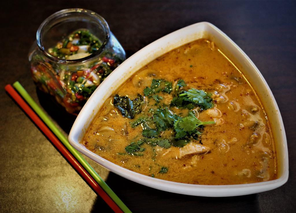 T1. Tom Yum Seafood · Shrimp, squid, mushrooms in lime juice, lemongrass galangal, Kaffir lime leaves, and Thai chili. Garnished with cilantro and roasted chili. Regular size served with white rice. 