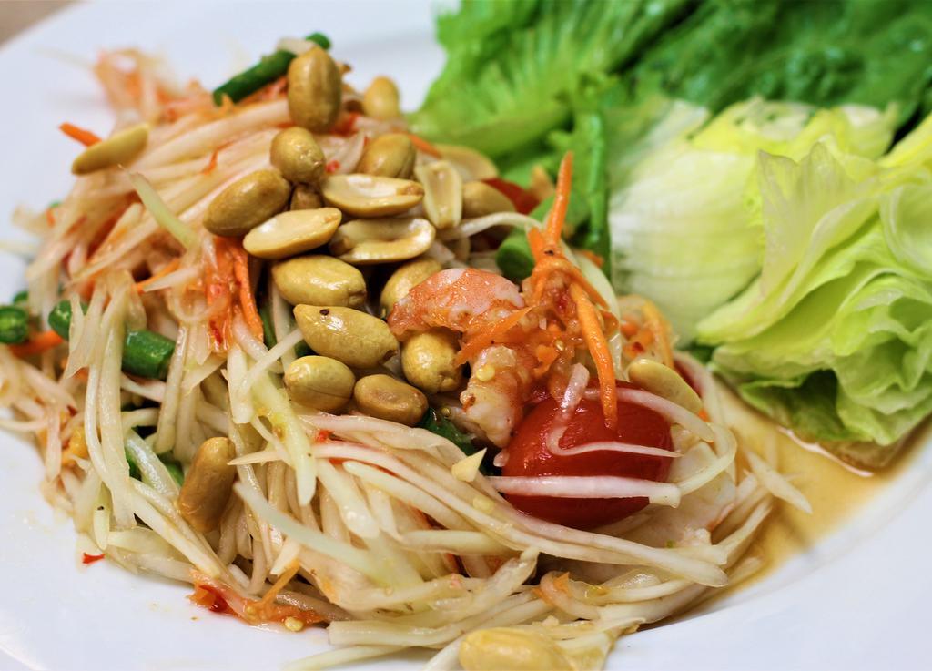 S2. Papaya Salad · Shredded green papaya, shrimp, tomatoes, green beans, garlic, and Thai chili tossed with tasty tamarind sauce mix. Topped with roasted peanuts. Served with a fresh green salad.