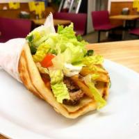 Greek Souvlaki · Pork, french fries, tzatziki sauce, lettuce, tomato and onion. Served on pita bread.