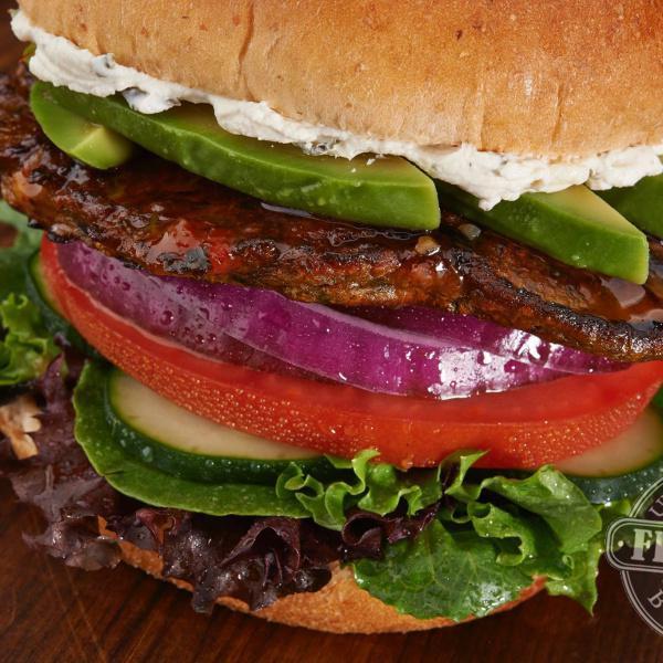 Black Bean Burger · Chipotle-flavored black bean burger, Boursin cheese, Thai glaze, avocado, cucumbers, spring mix, tomato and red onion.