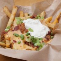 Smothered Fries · Served chili cheese sauce, bacon, sour cream and green onions.