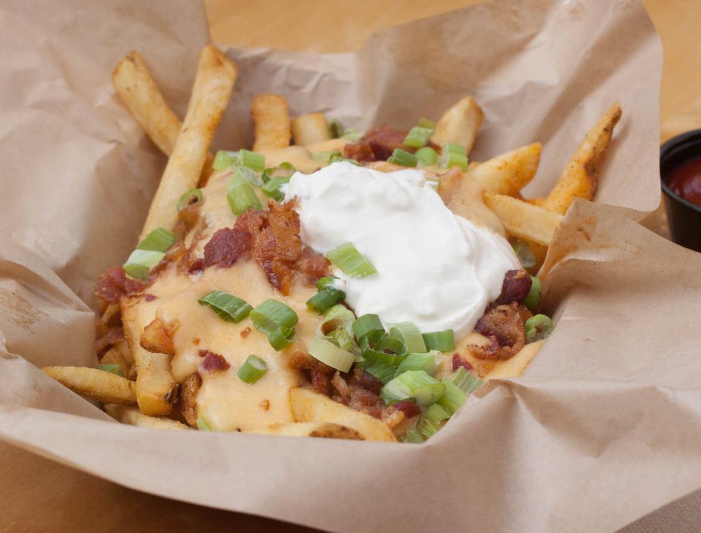 Smothered Fries · Served chili cheese sauce, bacon, sour cream and green onions.