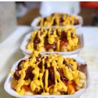 Salchi Papa · Hot Dog meat with melted cheese, fries, Monkey sauce and ketchup 