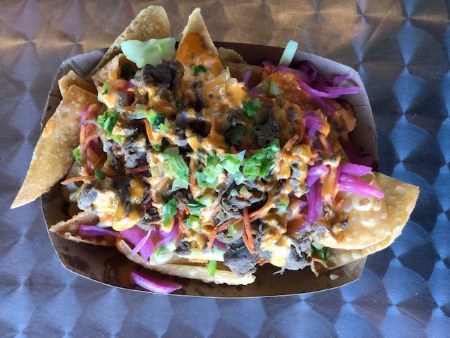 Bulgogi Wonton Nachos · Crispy wontons, fresh cucumber, pickled red onion, korean beef BBQ, a drizzle of boom sauce and topped with freshly chopped green onion.