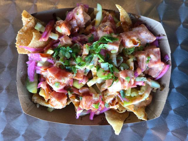 Spicy Tuna Wonton Nachos · Crispy wontons, fresh cucumber, pickled red onion, spicy tuna, masago, a drizzle of spicy sauce and eel sauce, and topped with freshly chopped green onion.