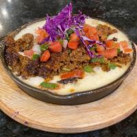 Queso Fundido · Hot melted Monterrey and Oaxaca cheese and spicy chorizo served with four corn tortillas.